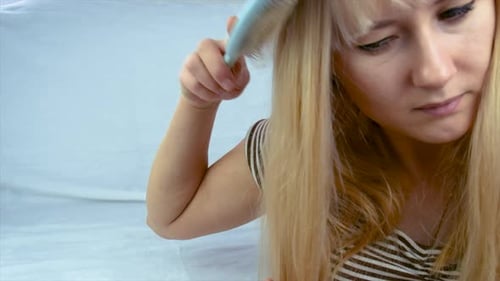Woman Brushing Long Blonde Hair