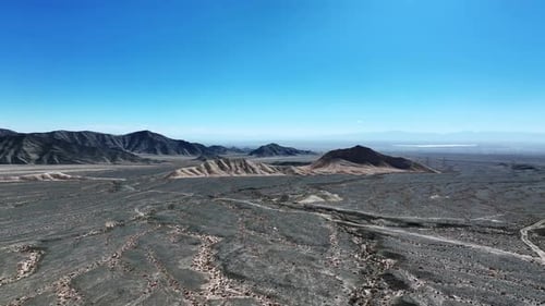 Expansive Desert Landscape with Distant Mountains Aerial View