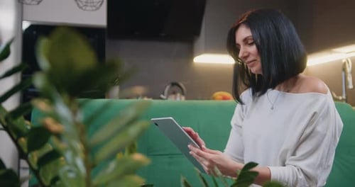 Woman Using Tablet Device at Home