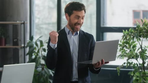 Happy Excited Businessman in Office Checking Email on Laptop Read Good News Man Winner Successful