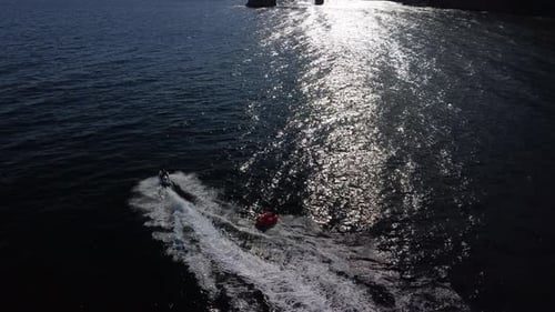 Jet Ski Pulls Tube on Sunny Ocean