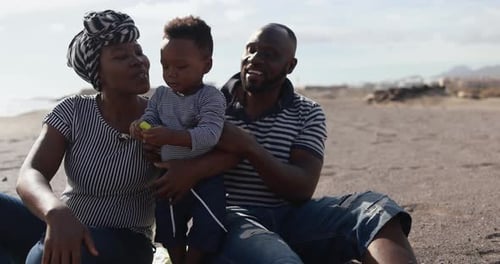 African family enjoying a playful summer day on the beach in South Africa