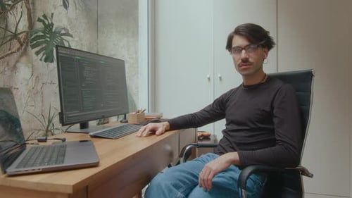 Portrait of Confident Programmer at Desk in Home Office