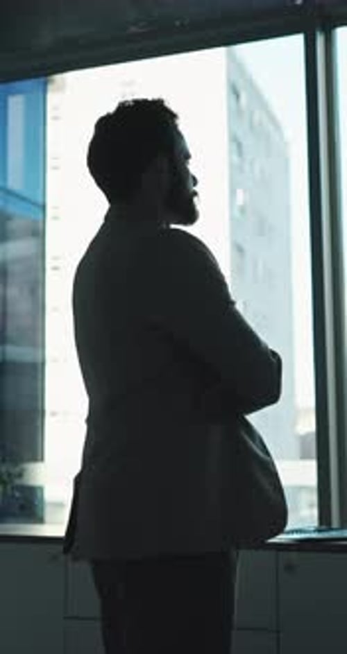 Thinking, man and arms crossed at window in office for architecture, career ambition and buildings