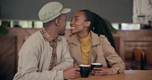 Couple, coffee or kiss with love at cafe, restaurant or diner for bond, care and romance