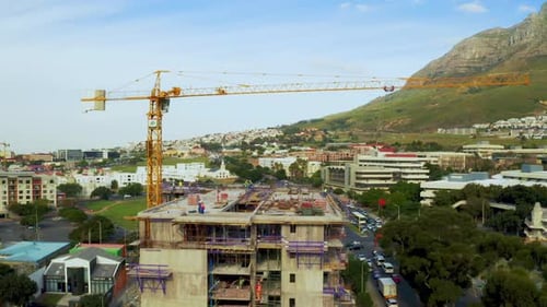 Urban Construction Site with Crane and Workers