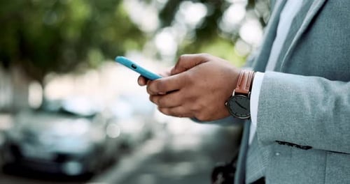 Text message, phone and hands of black man in city for communication, social media and connection