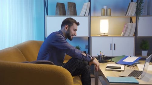 Successful businessman works on laptop.