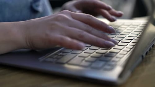 Woman's Hands Typing on Laptop Computer Keyboard