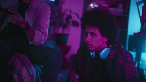 Best Friends Playing Video Game Console in Room with Neon Light