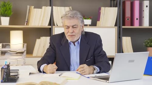 Stressed Man In Suit At His Workplace