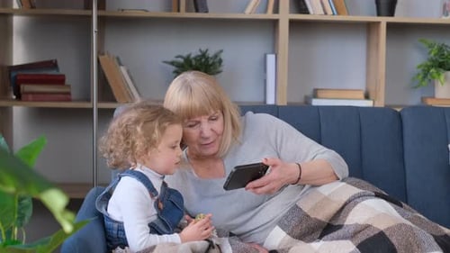 Grandmother and Child Spend Time Together Indoors