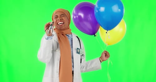 Doctor, woman and balloons with celebration green screen with hijab and happiness in medical care