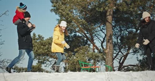 Happy Family Playing and Laughing in Winter Outdoors in Snow