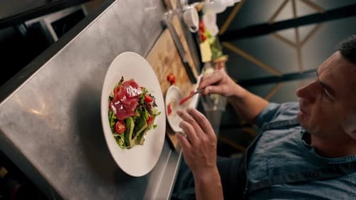 vertical video The chef of the Italian restaurant decorates the dish, lays out the ingredients