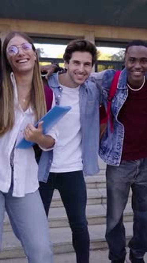 Portrait of Multiracial Group of Students Embraced Looking at Camera Smiling Outside University