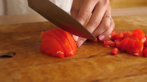 50. The tomato is cut with a kitchen knife. We cook at home.