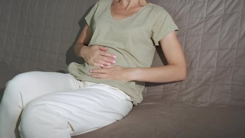 Pregnant Massaging Belly with Cramps