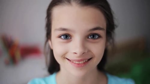Smiling girl looks directly at the camera