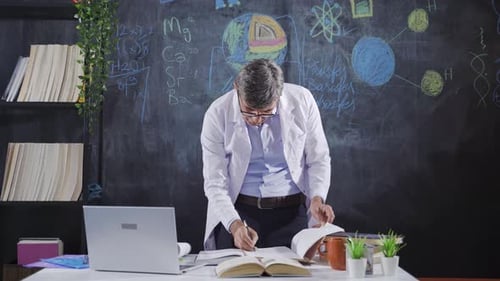 Scientist works and analyzes looking at books.
