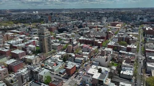 Aerial flyover Brooklyn District with housing area and avenues during sunny days in New York City