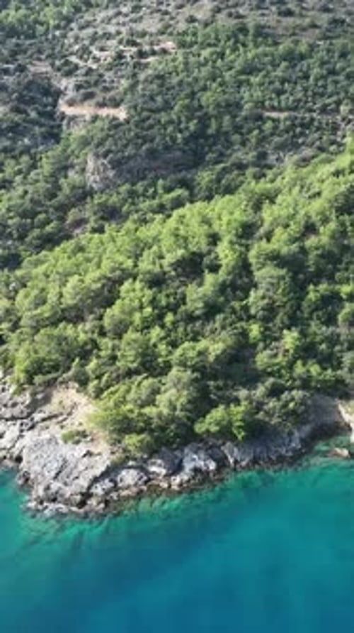 Breathtaking Aerial View of Turquoise Waters and Rocky Coastline