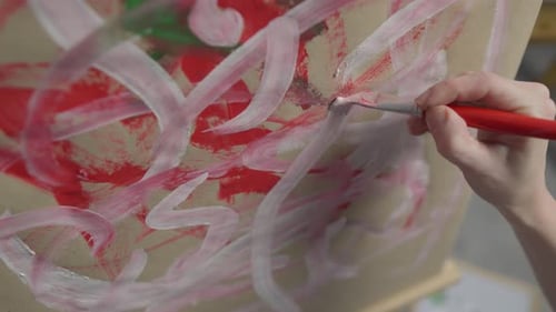 A Talented Innovative Woman Artist Paints with a Brush on Canvas Using Multicolored Paints