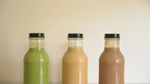 matcha green tea latte, chocolate and milk tea with pudding jelly in glass bottle on the table