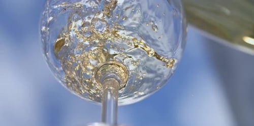 White wine pouring from bottle