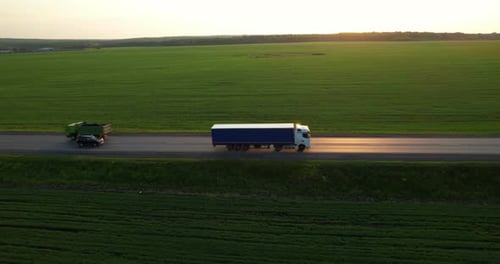 Aerial Shot Trucks and Cars Driving on the Road During Sunset