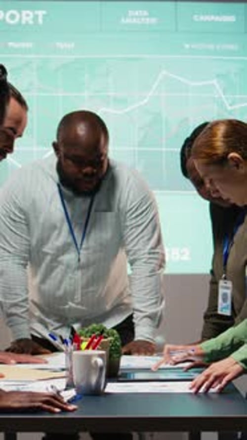 Vertical Video Diverse Group of Staff Collaborating on a Company Briefing After Hours