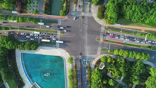 Aerial Drone Shot of Crossroad in the City Cars and Buses Driving By Avenue at Sunset Camera Moves