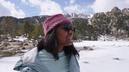 Woman Smiles in Snowy Mountain Winter Landscape
