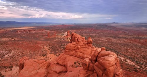 Footage over the whimsically-shaped red rocks in the dry desert.