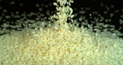 Rice Grains Pouring and Piling Up Close-Up