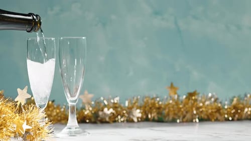 Champagne Poured into Flutes for Celebration Toast