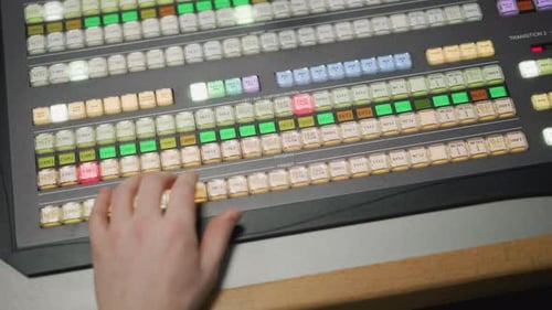 Hand Operating Professional Video Switcher for Camera Transitions in Live Production