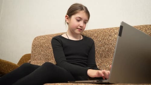 Medium Shot School Girl Typing on Laptop Doing Homework Kid Working on Assignments on Notebook