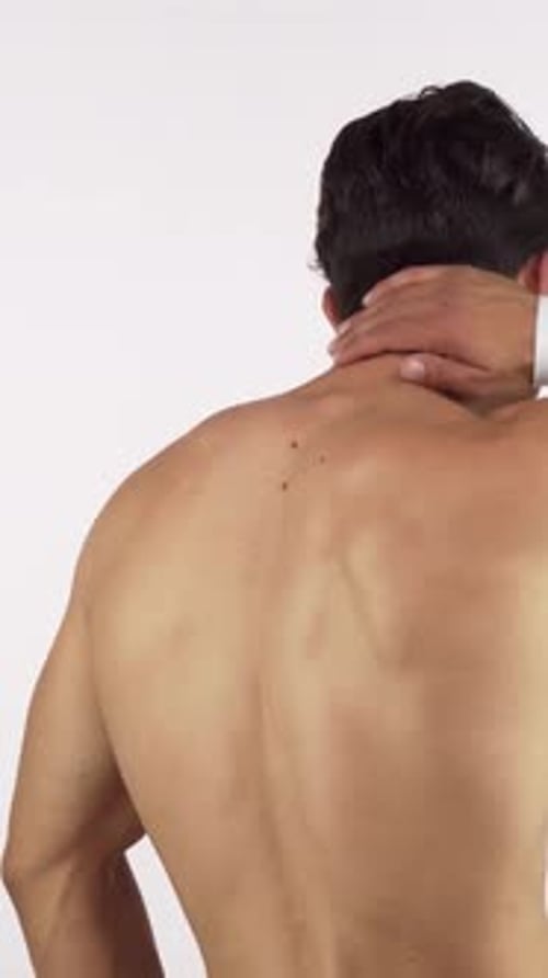 Adult Man Rubs Neck and Back in Discomfort
