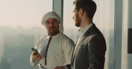 Businessmen Discuss Deal in High Rise Office