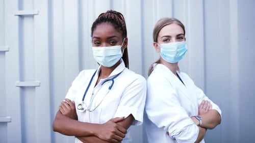 Confident Healthcare Workers Wearing Masks with Arms Crossed