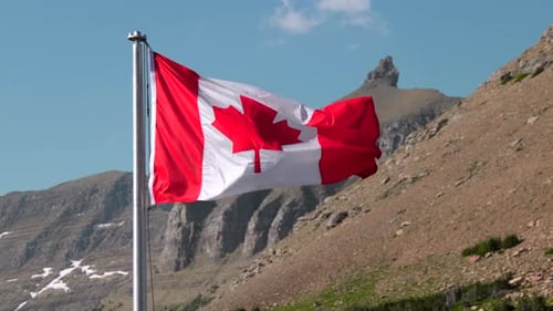 Canadian Flag Waving in Mountain Landscape