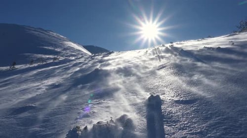 Windy Weather in Winter Mountains