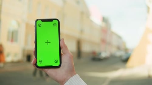 Woman Holding Smartphone with Chroma Key Closeup