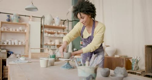 Female Artist Crafting in Pottery studio with Creative focus.