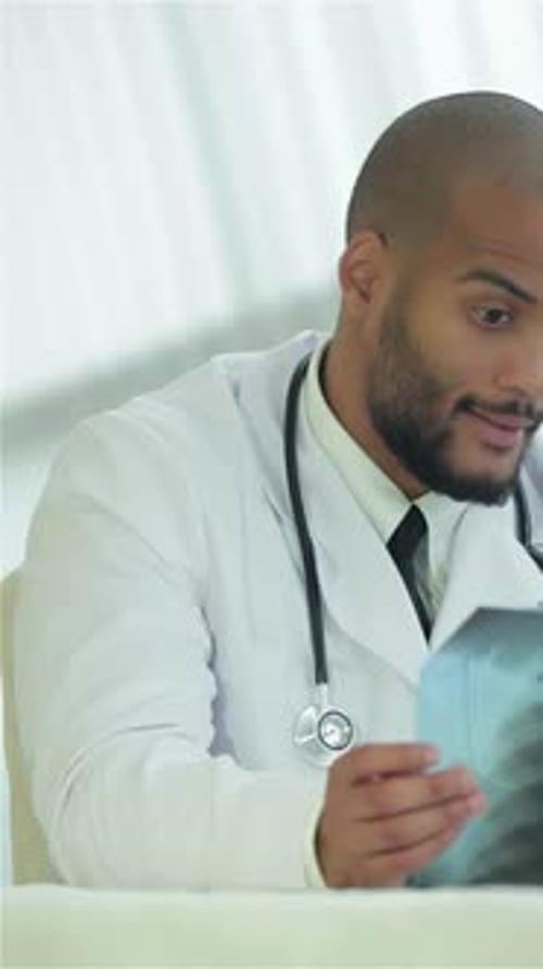 Doctor Examines X-Ray in Bright Office