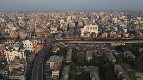 Drone Aerial View of Dhaka with Flyover, Traffic, and Crowded City Buildings