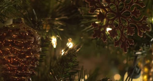 A close up slide on Christmas Tree decorations and ornaments, bokeh, selective focus, right to left
