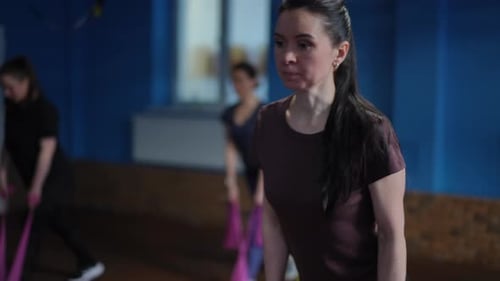 Women Exercising with Resistance Bands in a Gym