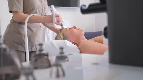 Woman Receives Facial Treatment at a Spa